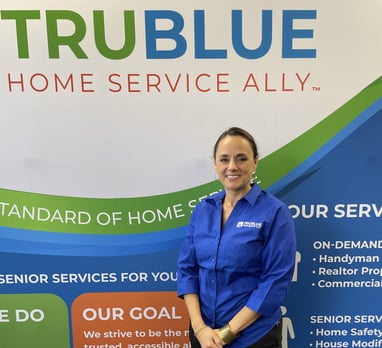 TruBlue franchisee standing in front of TruBlue advertisement